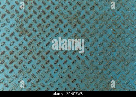 worn-out floor and footboard in a public park painted in shiny teal, blue, and green. Stock Photo