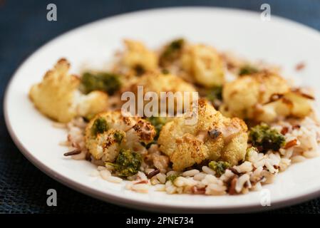 Roasted Cauliflower on Mixed Rice with Tahini and Zhoug Sauces Stock Photo