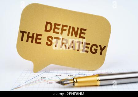 Business concept. On the business diagram is a pen and a sign with the inscription - Define The Strategy Stock Photo