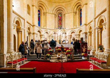 Tourists during a guided visit to the church of San Millán during Christmas. The church of San Millán. 11th century and 12th century. Segovia, Castill Stock Photo