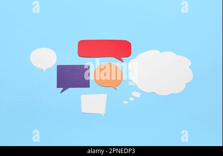 Blank paper speech bubbles on blue background Stock Photo