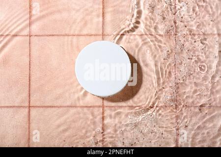 Plaster podium in water on pink tiled background Stock Photo