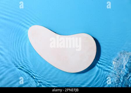 Plaster podium in water on blue background Stock Photo