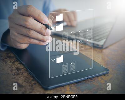 A Businessman Uses Document Management System (DMS) on Laptop: Office Software for Efficient Corporate File Archiving, Searching, and Management Stock Photo