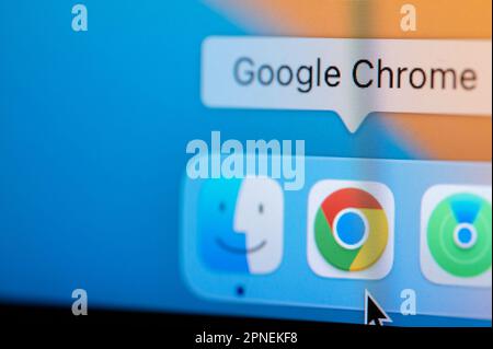 New york, USA - April 12, 2023: Open Google Chrome browser  in macbook dock to make conferencr call on computer screen close up view Stock Photo