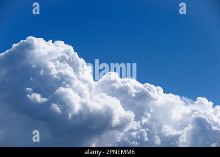 Pictured: Stormy clouds set against a bright blue sky Stock Photo - Alamy