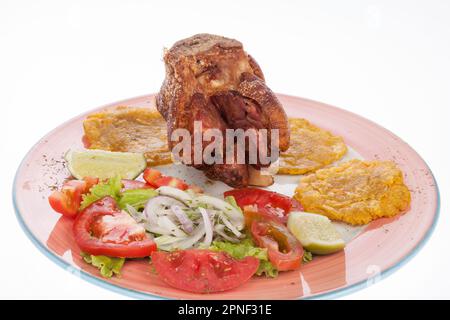 Fried Pork Knuckle With Salad And Patacones. Stock Photo