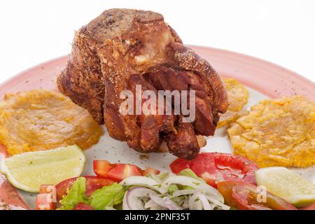 Fried Pork Knuckle With Salad And Patacones. Stock Photo