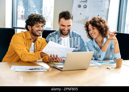 Creative designers working together on a design project, pantone selection. Teamwork concept. Positive multiracial successful designers working on a new project, discussing ideas, preparing concept Stock Photo