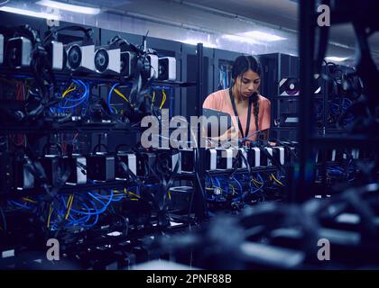 Female technician working in server room Stock Photo