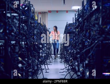 Female technician working in server room Stock Photo