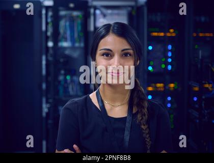 Portrait of smiling female technician in server room Stock Photo