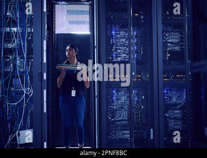 Female technician working in server room Stock Photo