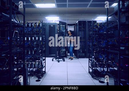 Female technician working in server room Stock Photo