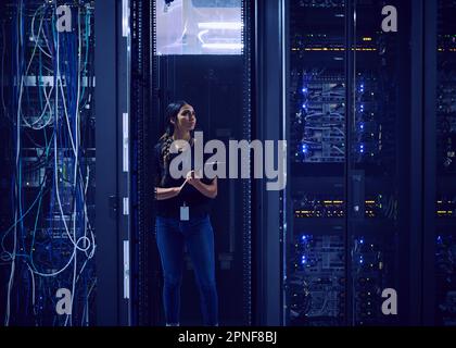 Female technician working in server room Stock Photo
