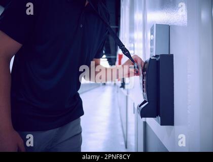 Midsection of man using security card to enter room in data center Stock Photo