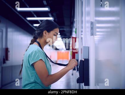 Woman using security card to enter room in data center Stock Photo