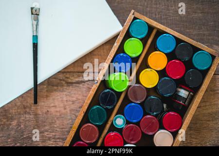 high angle view of a blank canvas, acrylics and other elements of a painter artist. Art workshop. Stock Photo