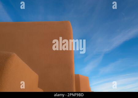 United States, New Mexico, Santa Fe, Adobe style walls against blue sky Stock Photo