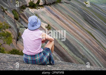 Australia, New South Wales, Bald Rock National Park, Woman looking at multicolored striped mountains Stock Photo
