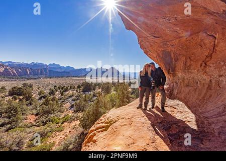 United States, Utah, Zion National Park, Senior couple standing on sandstone cliff Stock Photo