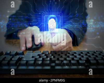 Businessman scans his fingerprint on a virtual futuristic screen for online biometric identity approval of security access. concept of safety for cy Stock Photo