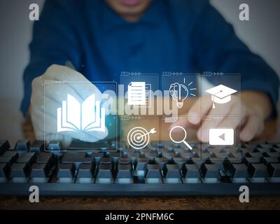 E-learning courses. A man attends an online lesson on a virtual digital screen. Internet lessons and online webinars. Technology for education concept Stock Photo