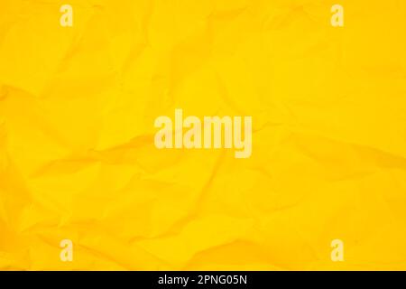 Abstract background from crumpled yellow paper texture. Stock Photo