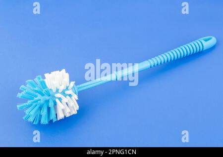 Toilet brush plastic blue on blue background. Stock Photo