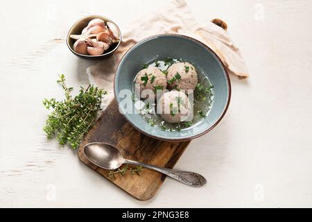 Canederli or Knodel in broth with green onion, typical pasta or dumplings for Alps, Alto Adige, German, Italian, Austrian cuisine. Made from stale bre Stock Photo