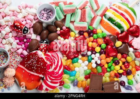 Assortment of colorful candy on a white background. Top view. Stock Photo