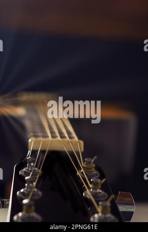 Spanish classical guitar with sun reflections on a black background Stock Photo
