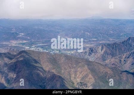 aerial landscape, from a glider,  with slopes of Langeberge range and Montague little town shot from west in bright cloudy summer light, near Montague Stock Photo