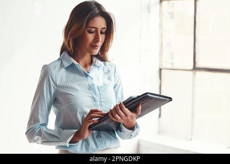 Getting it done is what she does. a confident businesswoman in a modern office. Stock Photo
