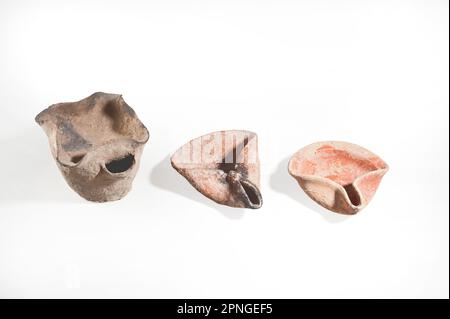 Ancient oil lamps Bronze Age 2000 BCE on the left and two Iron Age terracotta 8-10 century BCE Stock Photo