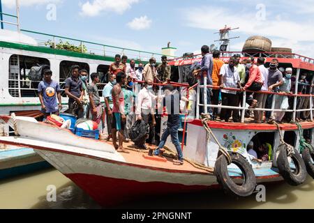 April 19, 2023, Narayanganj, Dhaka, Bangladesh: With the public holiday beginning today, Homebound Workers board a crowded ferry at Narayanganj Launch Terminal in Narayanganj, Bangladesh as they have already started leaving for their village homes to celebrate Eid-ul-Fitr. Narayanganj is very popular with more than 5,000 ready-made garments (RMG) factories in which 80% of the workers are from rural areas where Ferries are the easiest transportation available. The working-class people come to the City to work in the Garments and they only have a week-long vacation during Eid. So, this is the ti Stock Photo