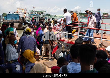 April 19, 2023, Narayanganj, Dhaka, Bangladesh: With the public holiday beginning today, Homebound Workers board a crowded ferry at Narayanganj Launch Terminal in Narayanganj, Bangladesh as they have already started leaving for their village homes to celebrate Eid-ul-Fitr. Narayanganj is very popular with more than 5,000 ready-made garments (RMG) factories in which 80% of the workers are from rural areas where Ferries are the easiest transportation available. The working-class people come to the City to work in the Garments and they only have a week-long vacation during Eid. So, this is the ti Stock Photo