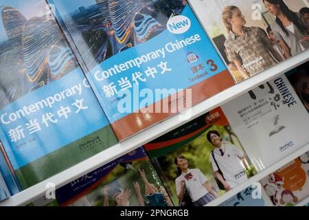 Educational text books are displayed on the 'China International Publishing Group' (CIPO) during the first day of the London Book Fair at Hammersmith's Olympia Exhibition Hall, on 18th April 2023, in London, England. The three-day international London Book Fair (LBF) is an annual publishing industry expo and Europe's largest spring book fair that typically attracts 25,000 visitors; exhibitors from across the publishing sector; authors hoping for their book ideas to be commissioned and where international publication rights deals are made for foreign editions. Stock Photo