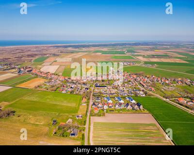 High angle Drone Point of View on Village of Den Hoorn, located on the island of Texel, The Netherlands. The Wadden Sea can be seen in the distance. Stock Photo