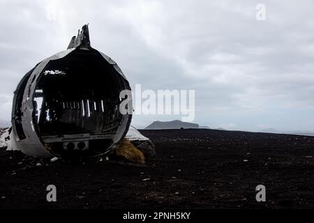 Iceland - August 2021: Sunset view of the old crashed plane wreck abandoned in a remoted black sand beach in Iceland Stock Photo