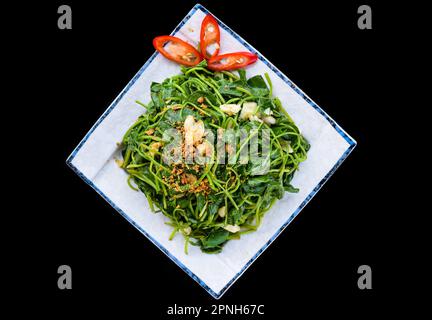Vietnamese stir fried Spinach with garlic on black background for a menu Stock Photo