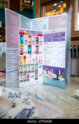 A menu card from a JD Wetherspoons pub. The card shows the prices of the craft and world beers and wines they offer for sale in the pub Stock Photo