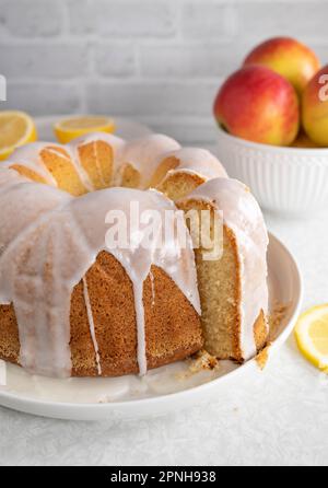 Bundt cake with lemon glaze on kitchen counter Stock Photo
