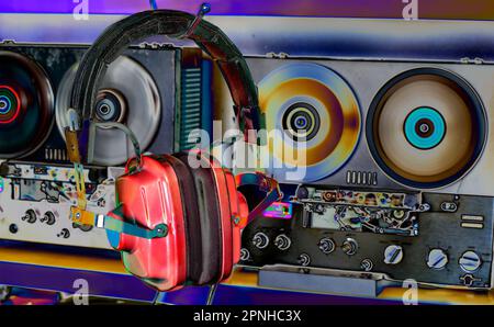 vintage headphones and reel to reel tape recorders, solarized colors, retro audio gear, nostalghia and hipster lifestyle Stock Photo