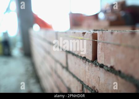 Brickwork of the wall correct laying of red brick for reliable wall of strong house or brick building Stock Photo