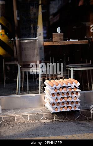Cartons of fresh eggs sitting in front of restaurant Seoul South Korea Stock Photo