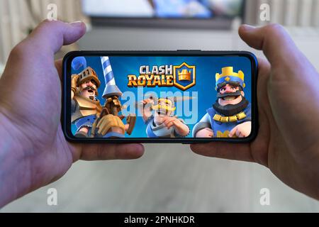 Playing Clash Royale mobile game. Point of view gaming Clash Royale game on smartphone Stock Photo