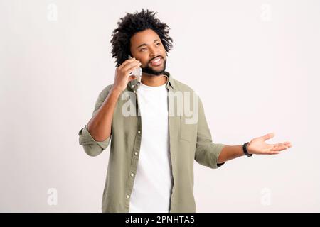 Mobile communication. Waist up portrait view of handsome 30s man making phone call, african guy with curly hairstyle talking on cell phone with glad face expression, isolated on white background Stock Photo