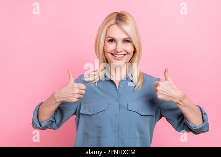 Photo pensioner pretty lady approve good job raise both hands arms thumbs up wear blue smart casual blouse isolated pink color background Stock Photo