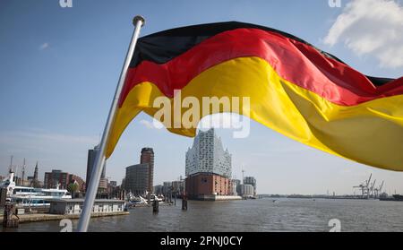Hamburg, Germany. 17th Apr, 2023. A German flag flies at the stern of an excursion ship in the port of Hamburg above the Elbe Philharmonic Hall. Credit: Christian Charisius/dpa/Alamy Live News Stock Photo